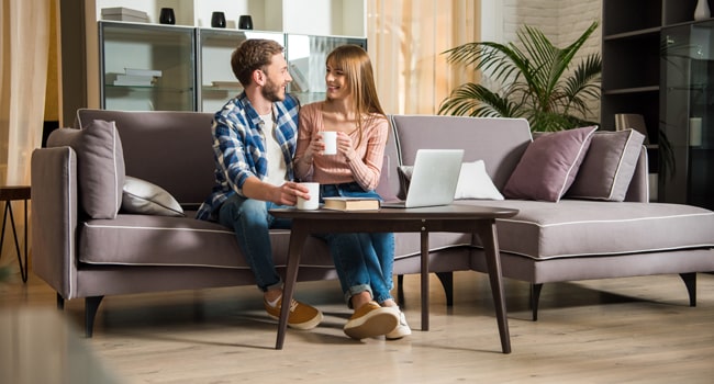 Radon Testing keeps your family safe from cancer causing substances. Images shows happy couple snuggling on the couch.